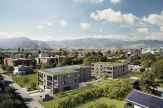 Wohnanlage Flurstraße, Lustenau. Inmitten einer ruhigen, natürlichen Umgebung entstehen zwei Winkelformen und eröffnen einen gemeinsamen zentralen grünen Innenhof. Ein Fußweg durchquert die Anlage in Nord-Süd Richtung mit flankierenden Kinderspiel- und Aufenthaltsflächen sowie überdachten Eingangsbereichen zu den Wohnhäusern. ZIMA Wohn Baugesellschaft.